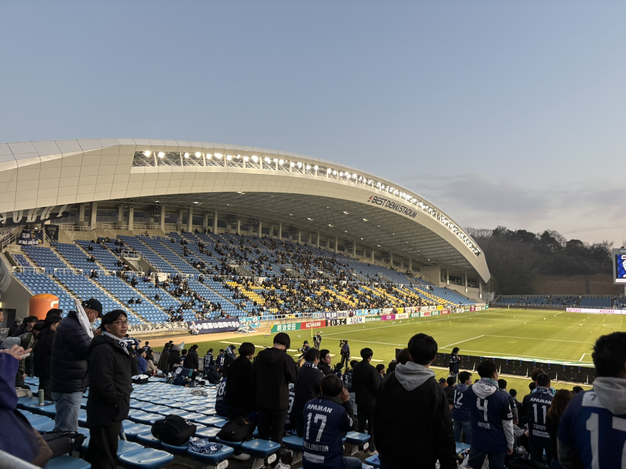 Inside Best Denki Stadium Fukuoka before the J-League match with green pitch and spectators