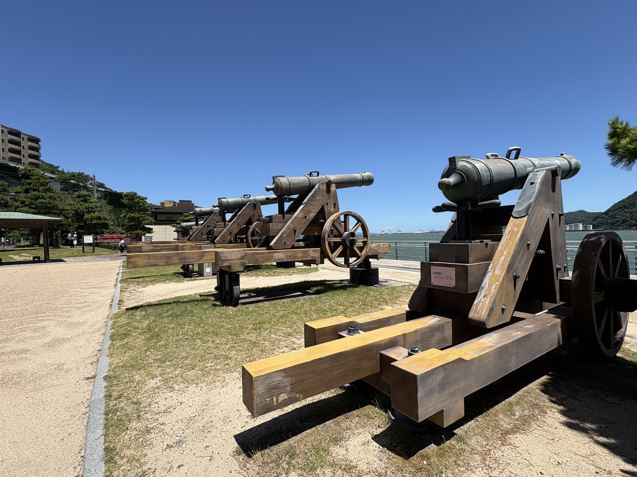Dannoura Choshu cannon replica iron cannon display Mimosuso river park Shimonoseki blue sky sea