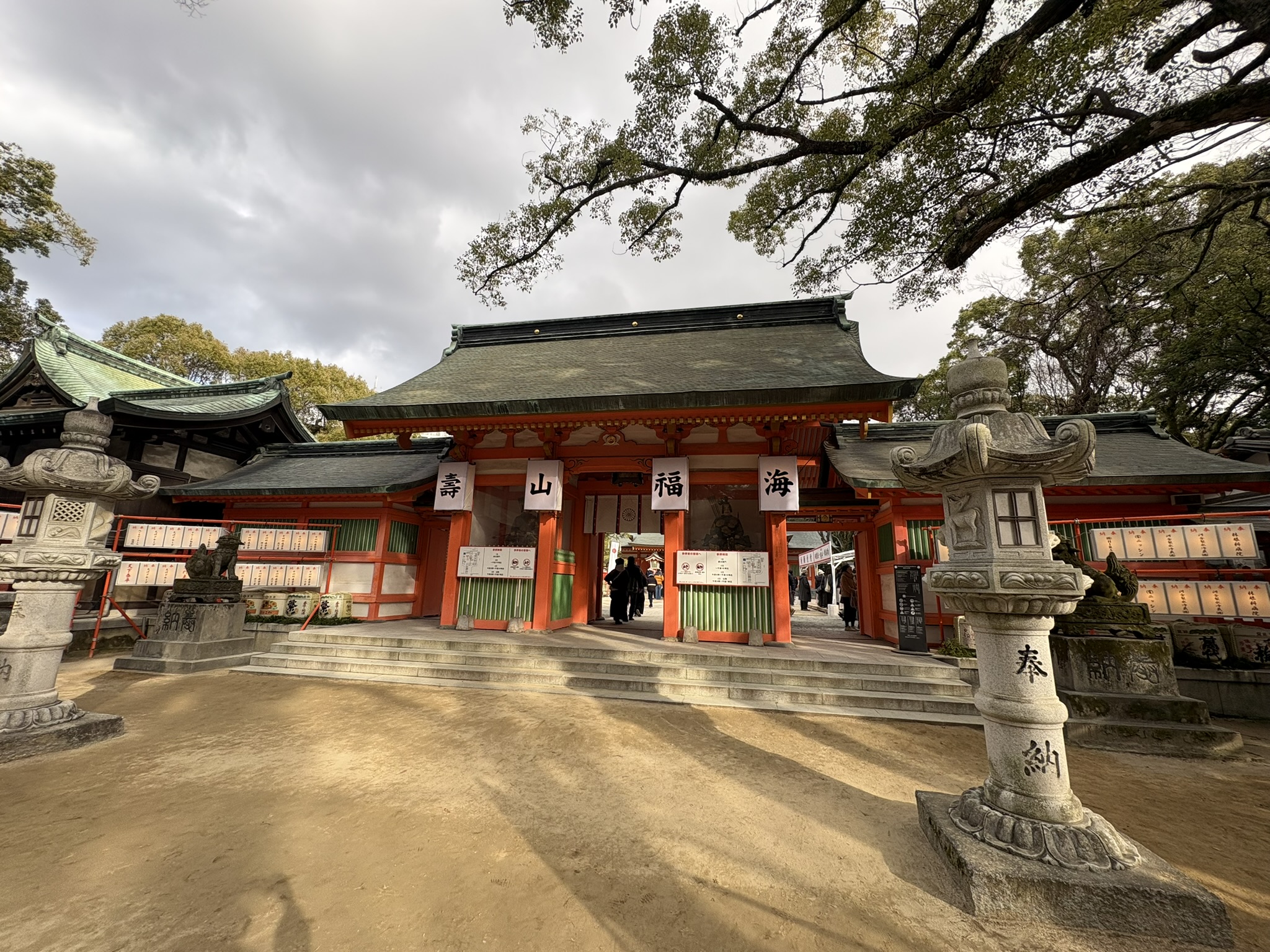Fukuoka Sumiyoshi Shrine stone torii lantern night approach new year atmosphere warm light