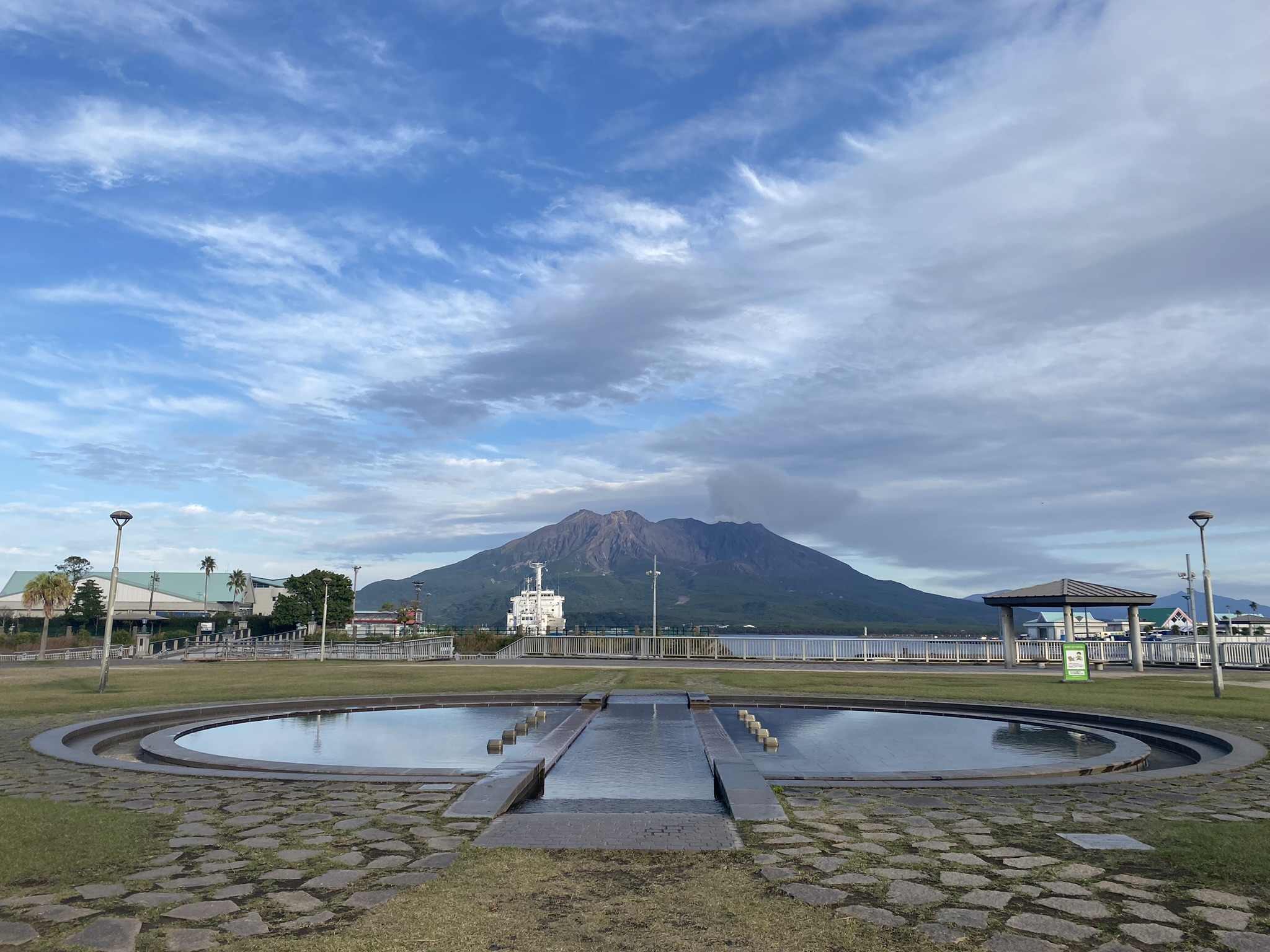 Kagoshima waterfront park circular reflecting pool with Sakurajima volcano in background