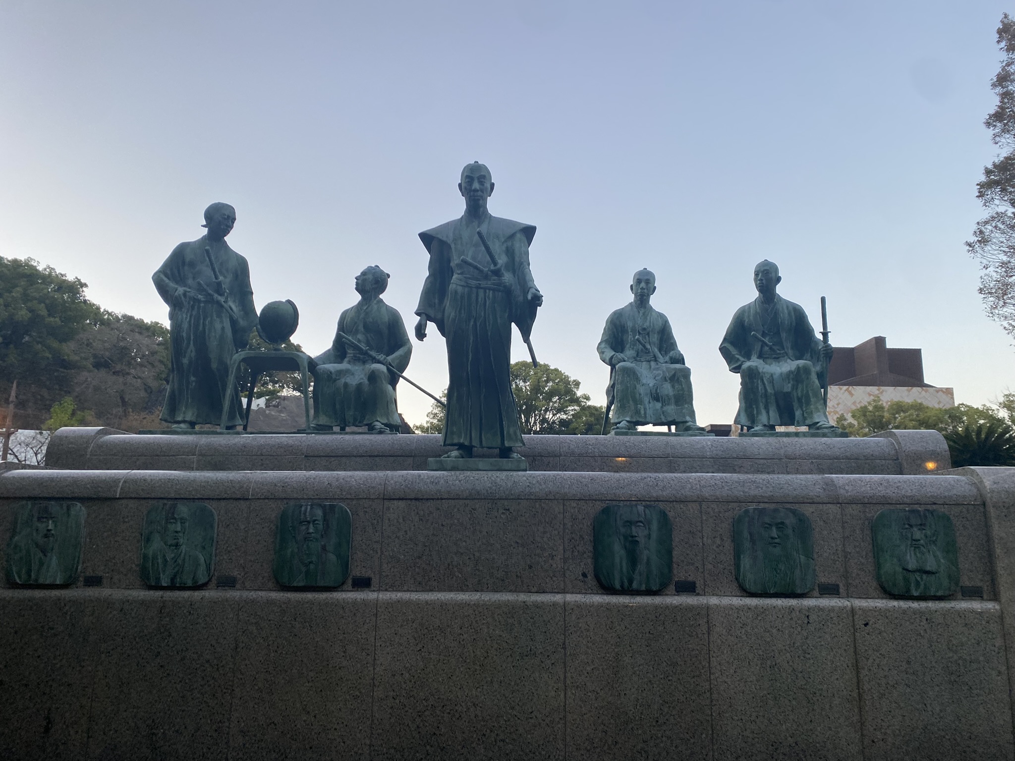 Group bronze statues of Kato Kiyomasa and retainers near Kumamoto Castle at dusk