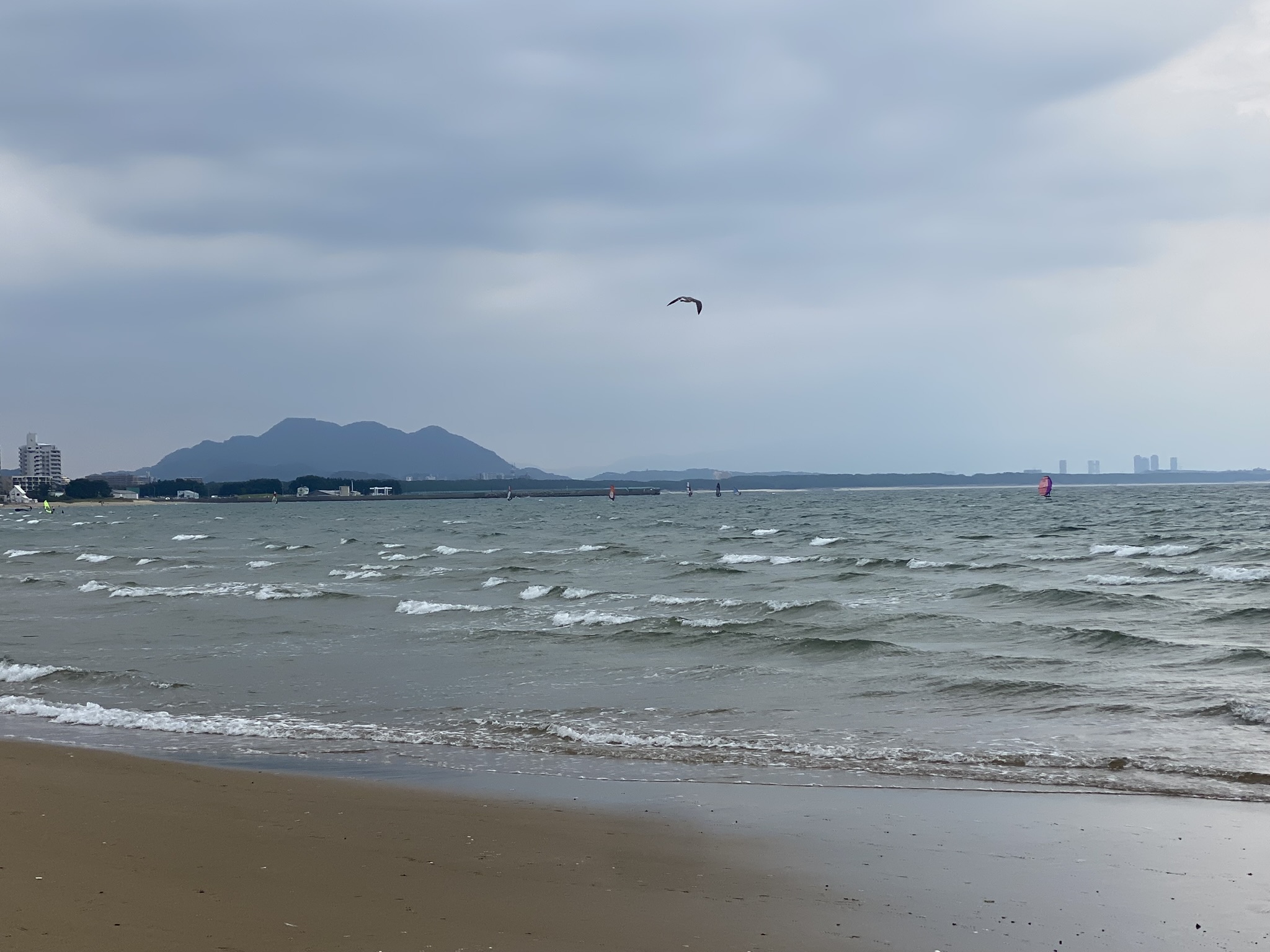 Miyajidake Fukuma beach sea waves kite flying mountain silhouette cloudy sky
