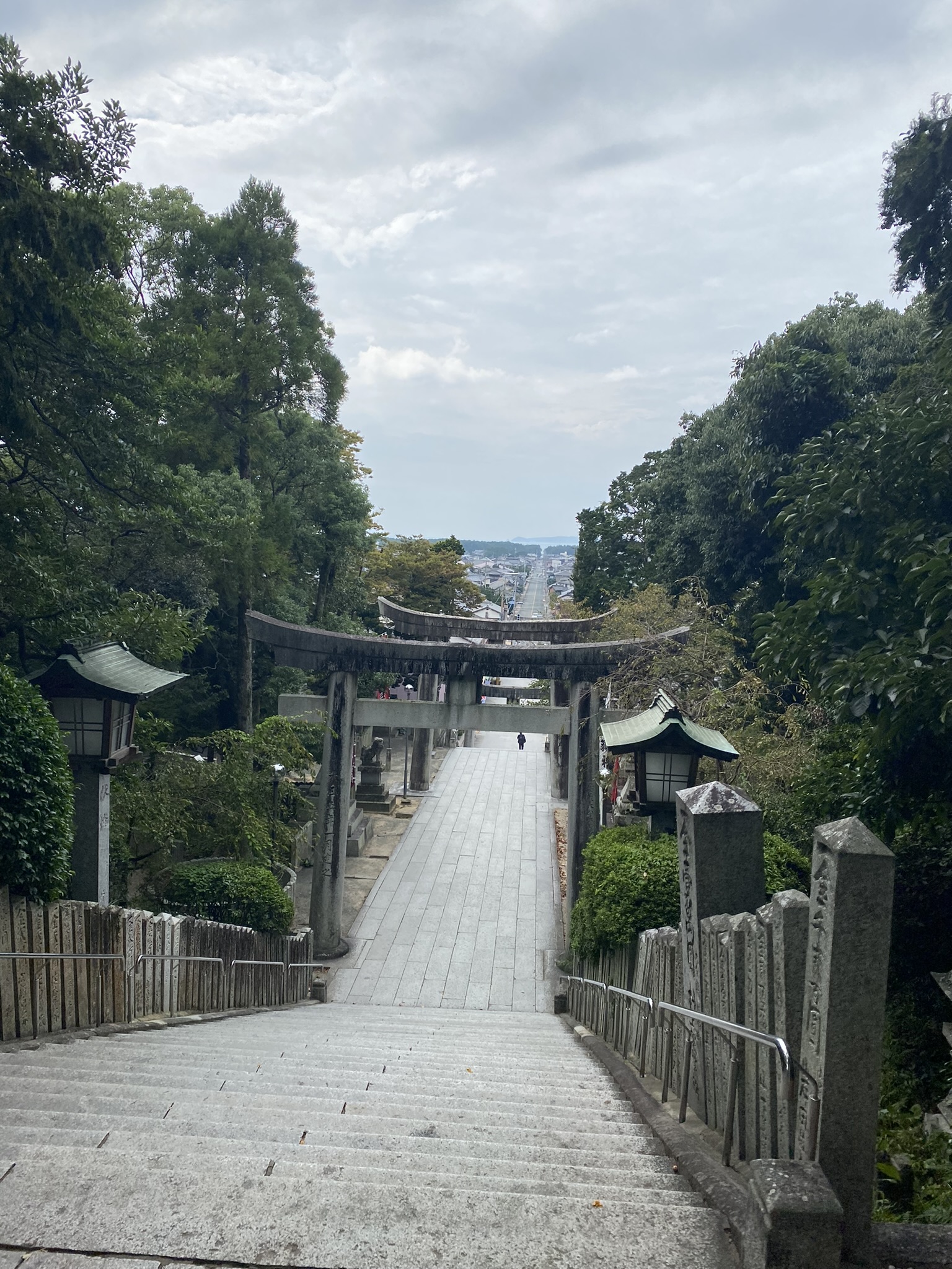 Miyajidake Jinja approach seen from top looking down torii gate and path toward sea