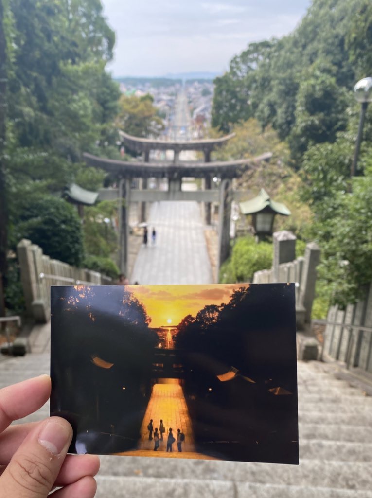 Miyajidake Jinja holding postcard of Hikari no Michi light of the road sunset view approach background