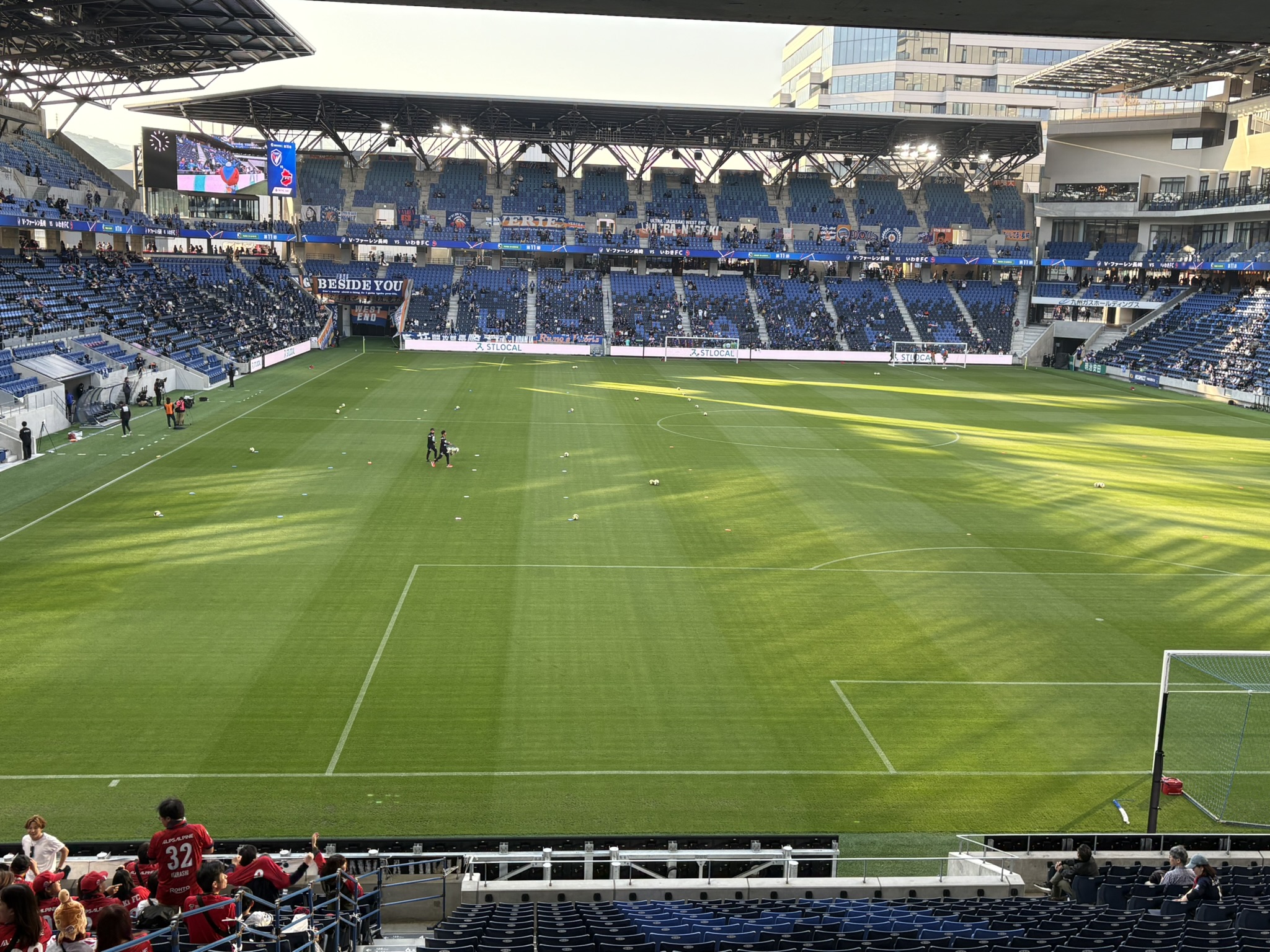 PEACE STADIUM interior view from stands showing green pitch and blue seats Nagasaki