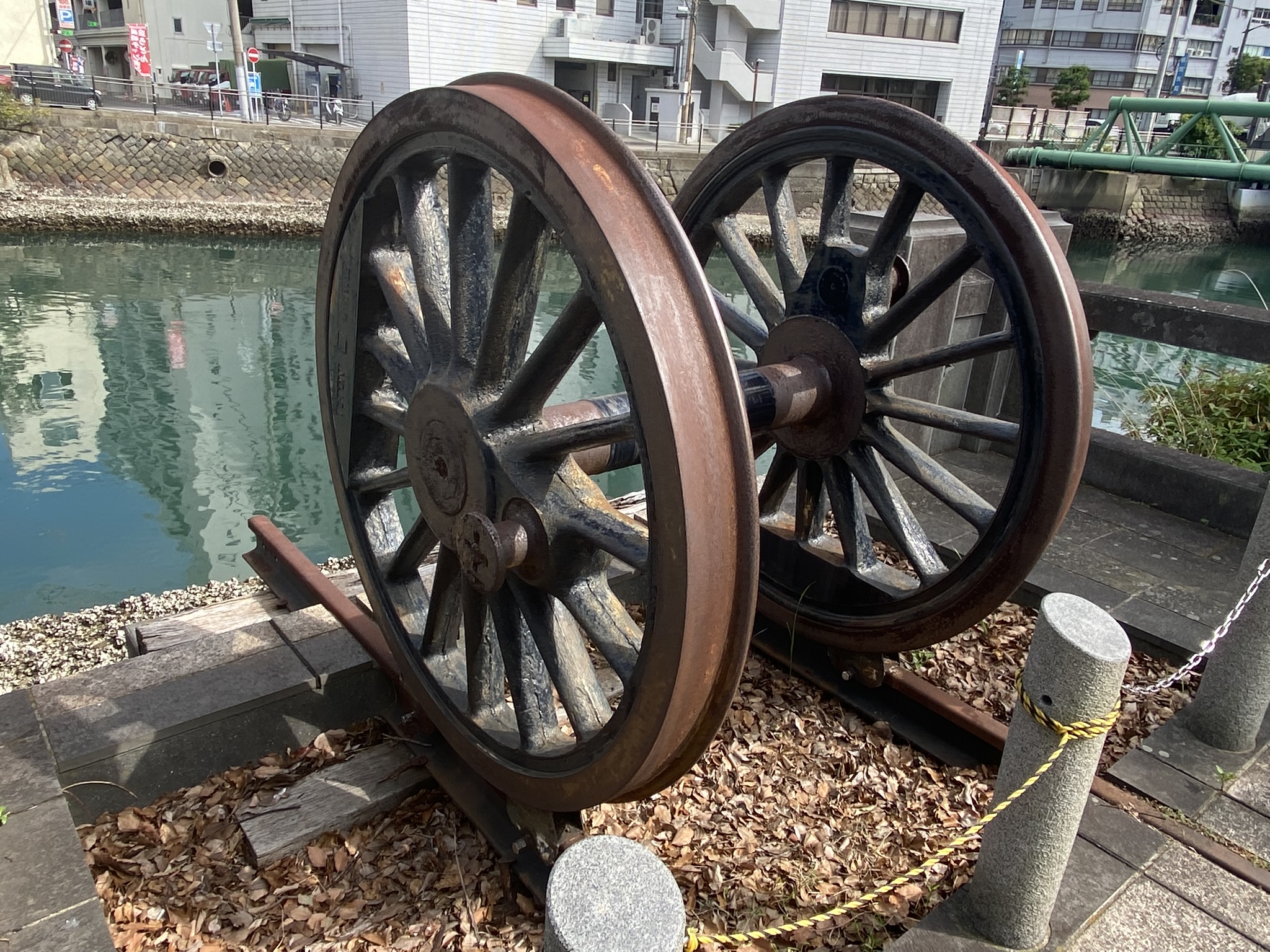 Railway wheel sculpture art installation at Nagasaki port waterfront