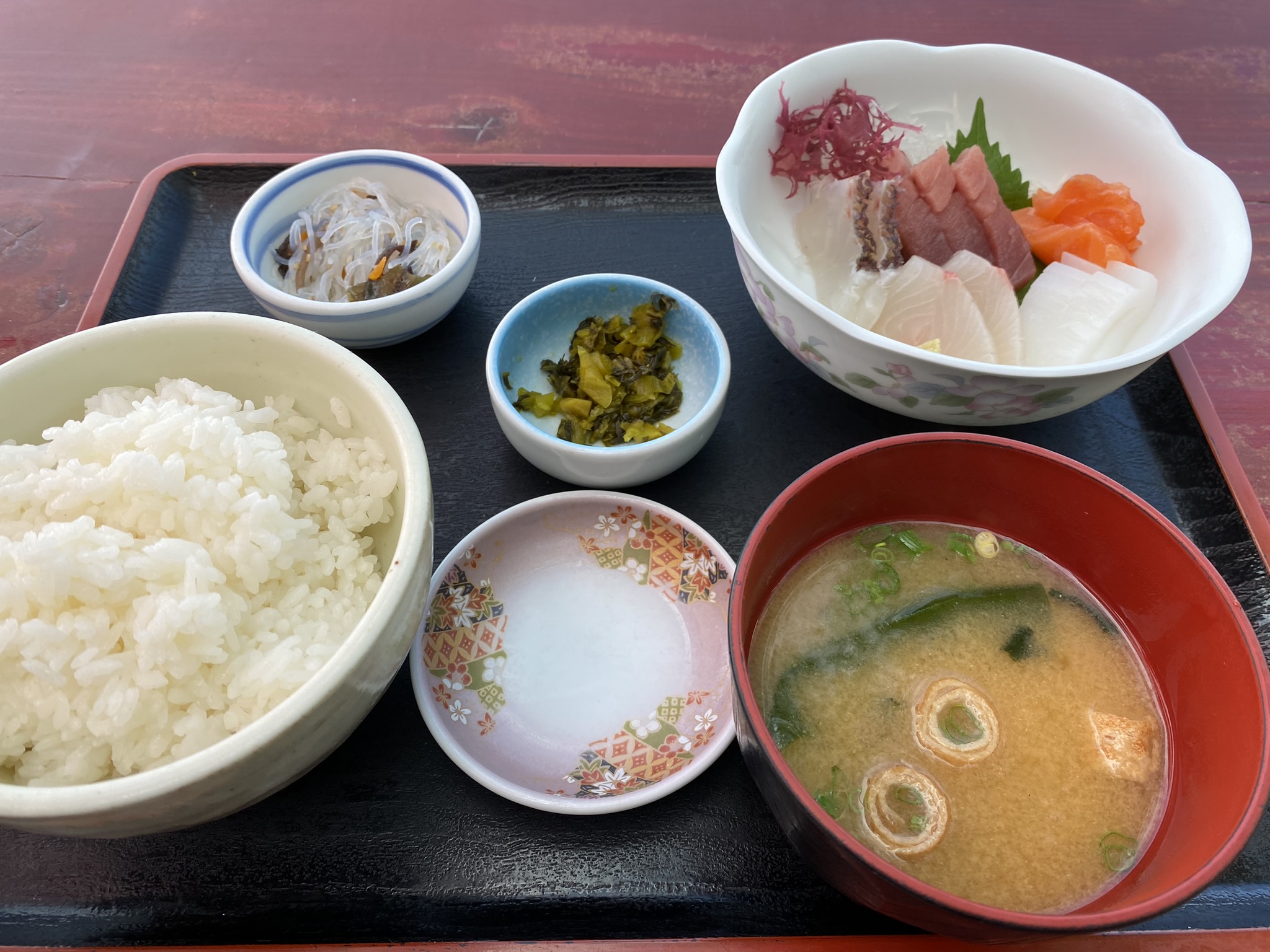Fresh sashimi set meal with rice miso soup and side dishes at Nagasaki port restaurant