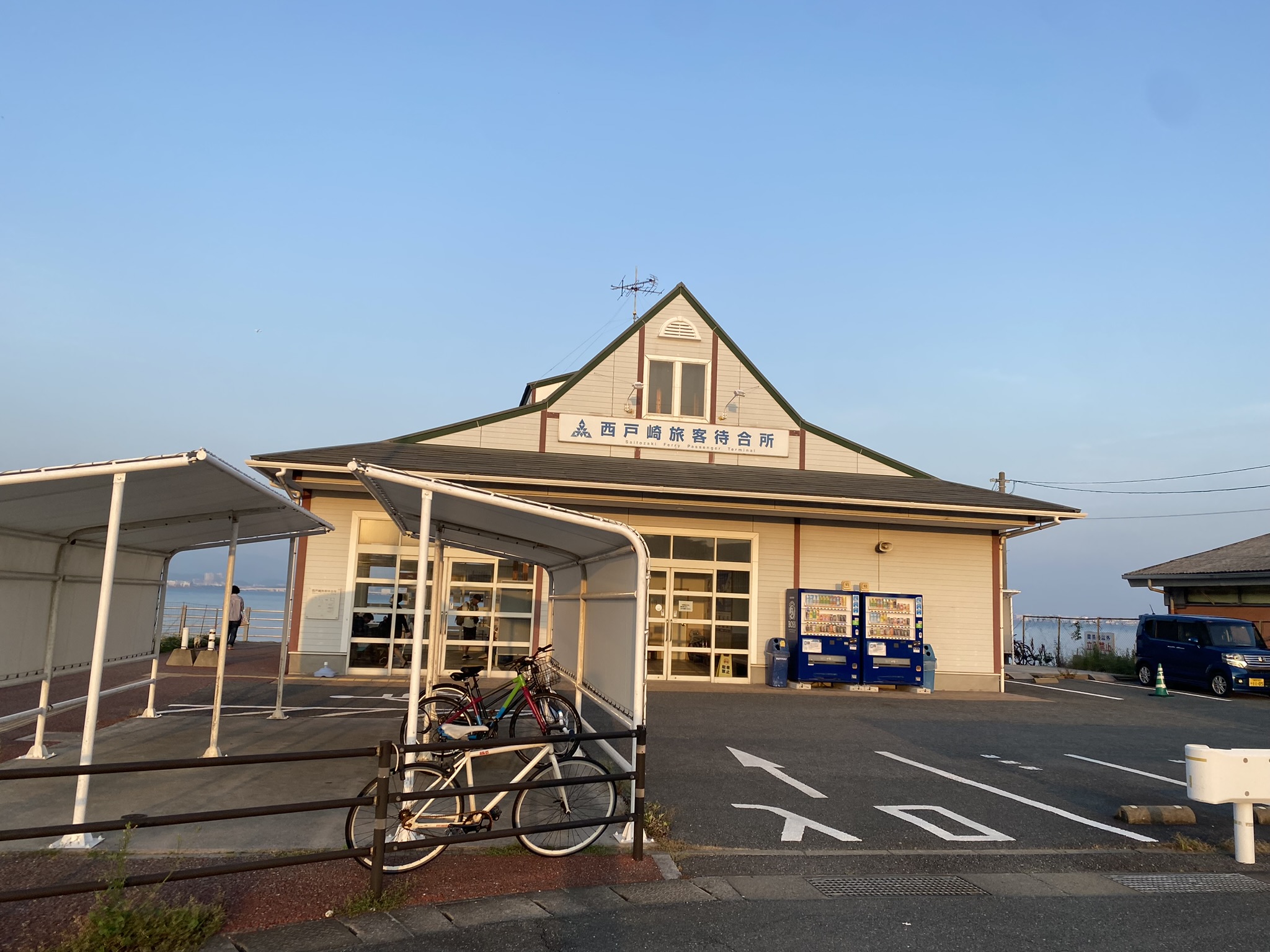 Nishisaitozaki ferry passenger waiting hall exterior evening sky blue bicycle parking