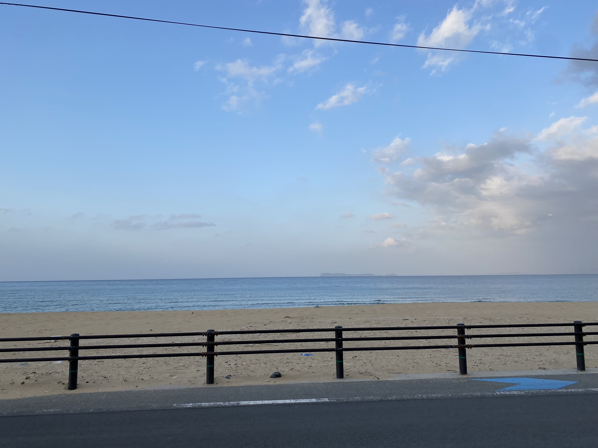 Shikanoshima island sandy beach clear blue sea waves calm summer
