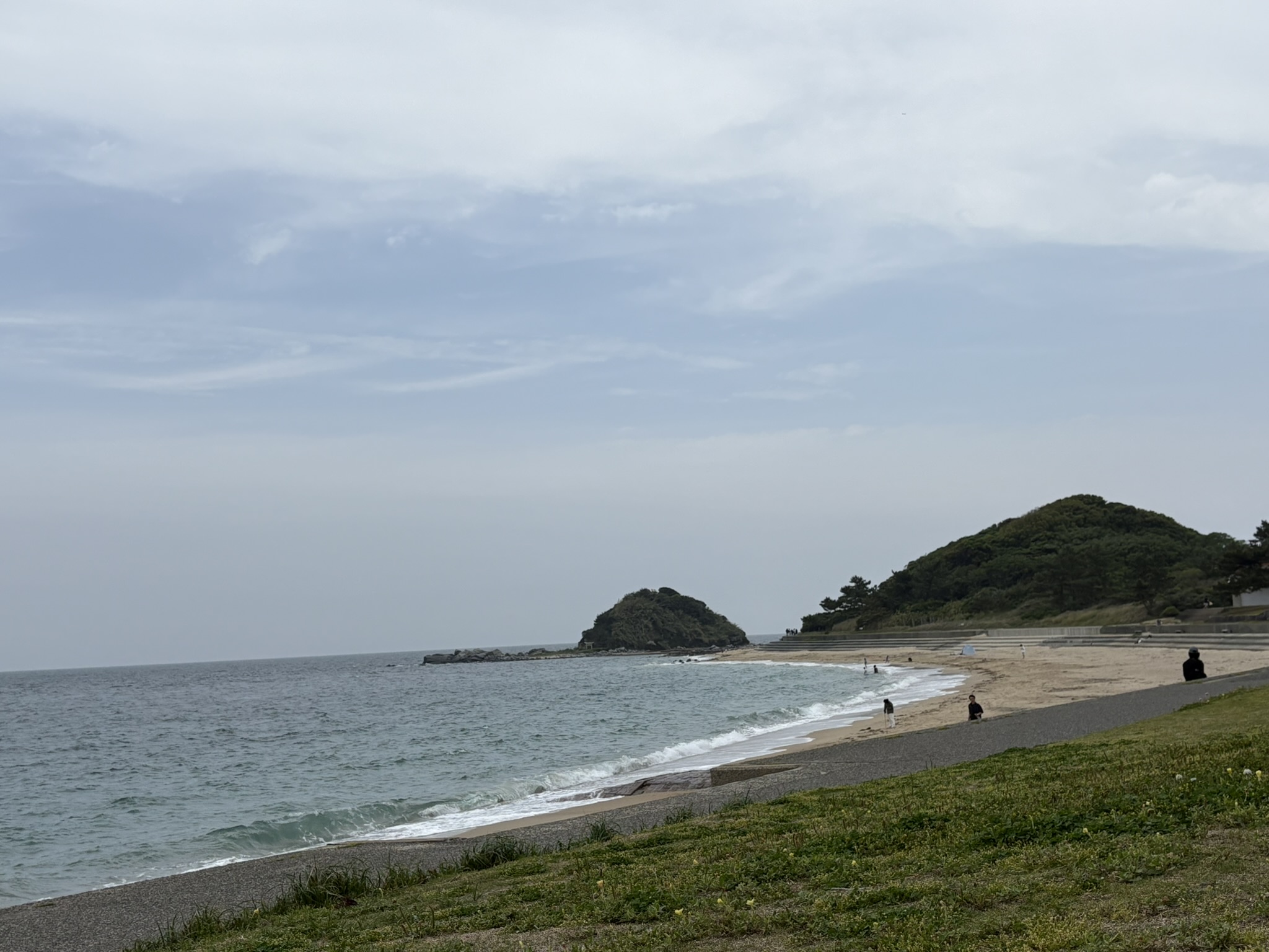 Shikanoshima island beach rock formation small islet ocean waves overcast sky