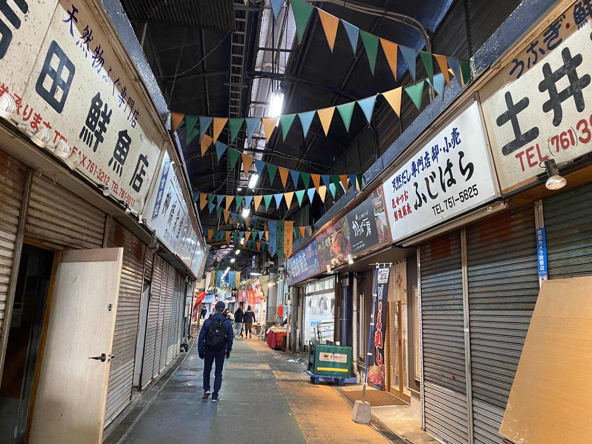 People walking through Yanagibori market arcade in Fukuoka with local shops